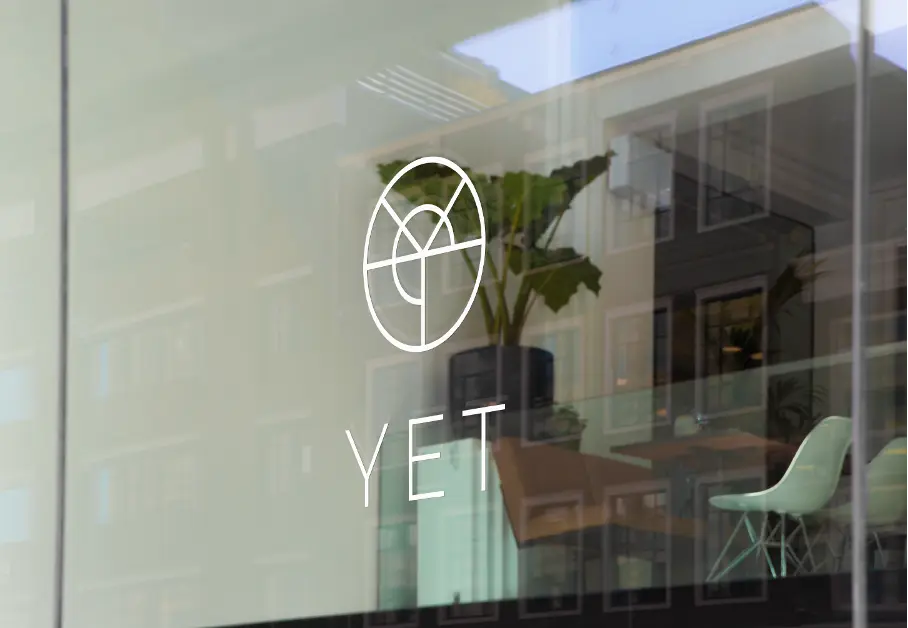 YET MBTI white logo on window for about YET.